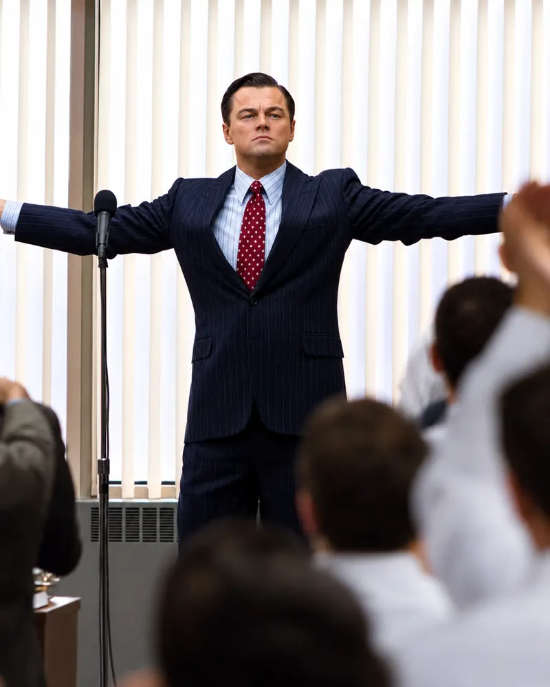 Jordan Belfort commanding the room during a sales presentation